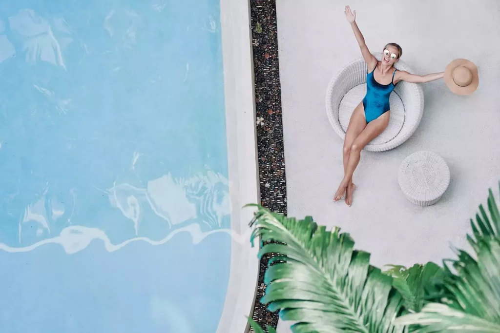 Woman laying next to a pool
