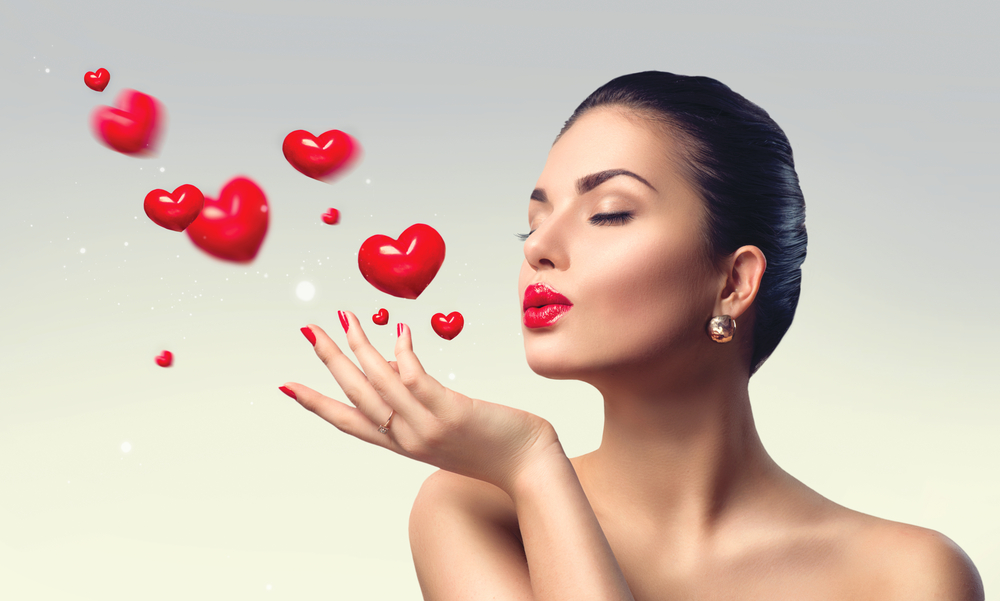 Woman blowing heart kisses